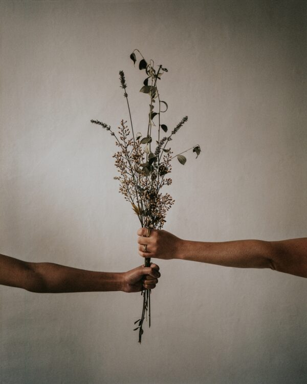aesthetic hands with flowers, beige background
